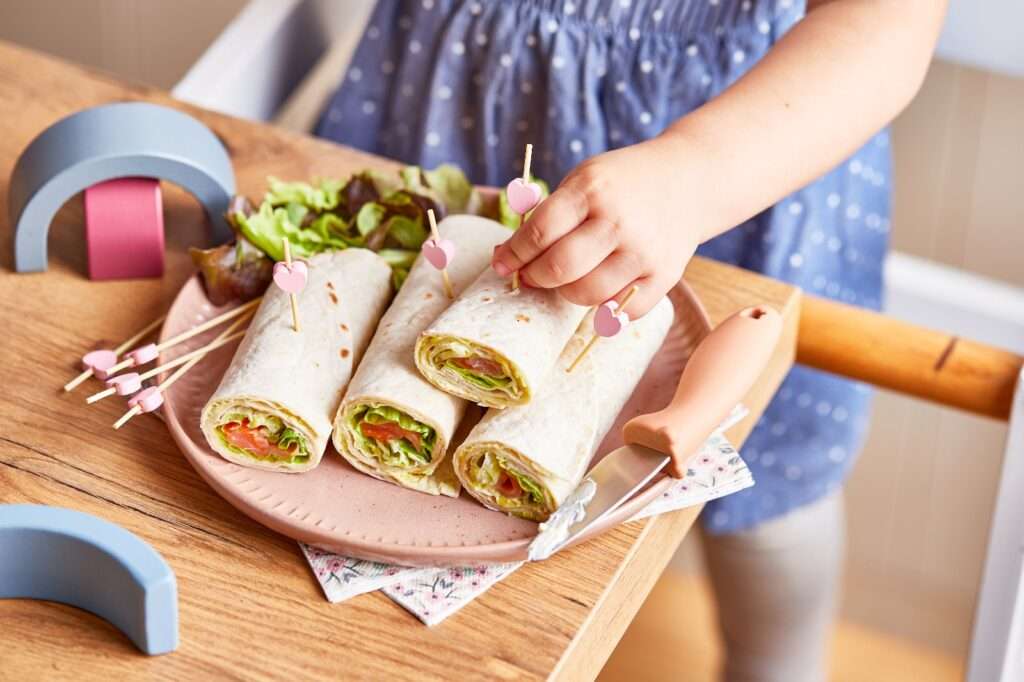 Toddler's Motor Cooking Skills, young girl making wraps